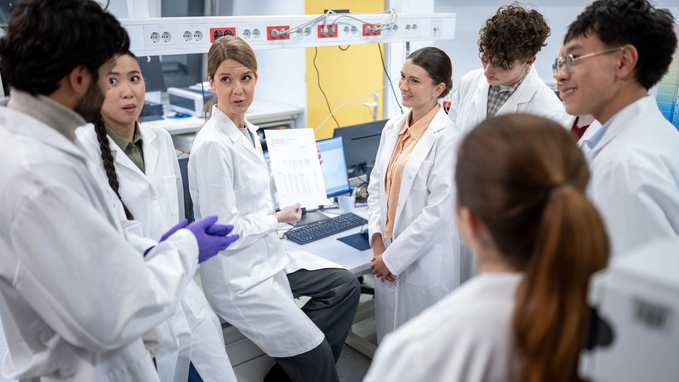 Scientists collaborating in a high-tech lab focused on early detection and medical imaging research